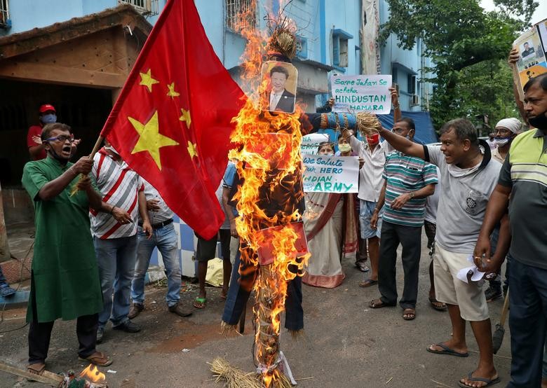 Demonstrators shout slogans as they burn an effigy depicting Chinese President Xi Jinping during a protest against China, in Kolkata, India. REUTERS/Rupak De Chowdhuri    